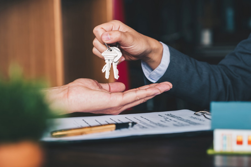 A real estate agent handing over the keys to a client