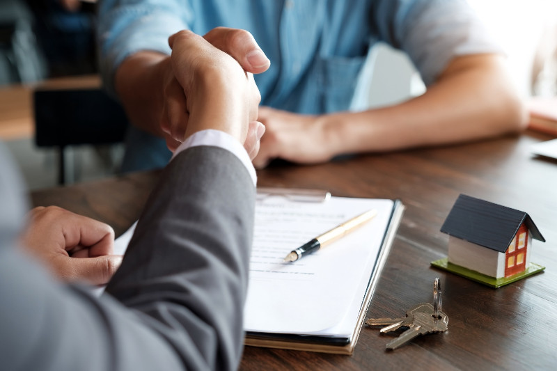 An agent and a client shaking hands